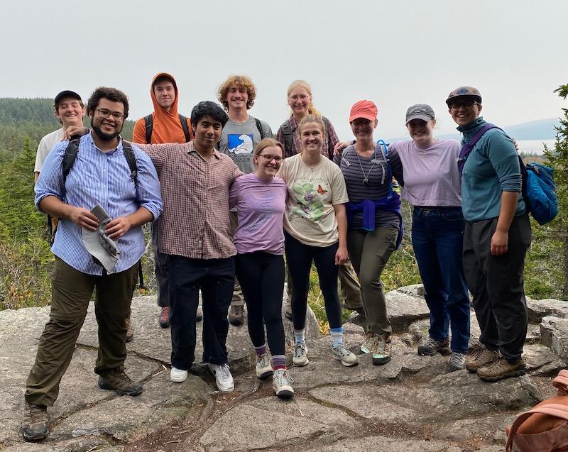 学生 and 教师 stop for a picture during their hike on the Schoodic Head Trail