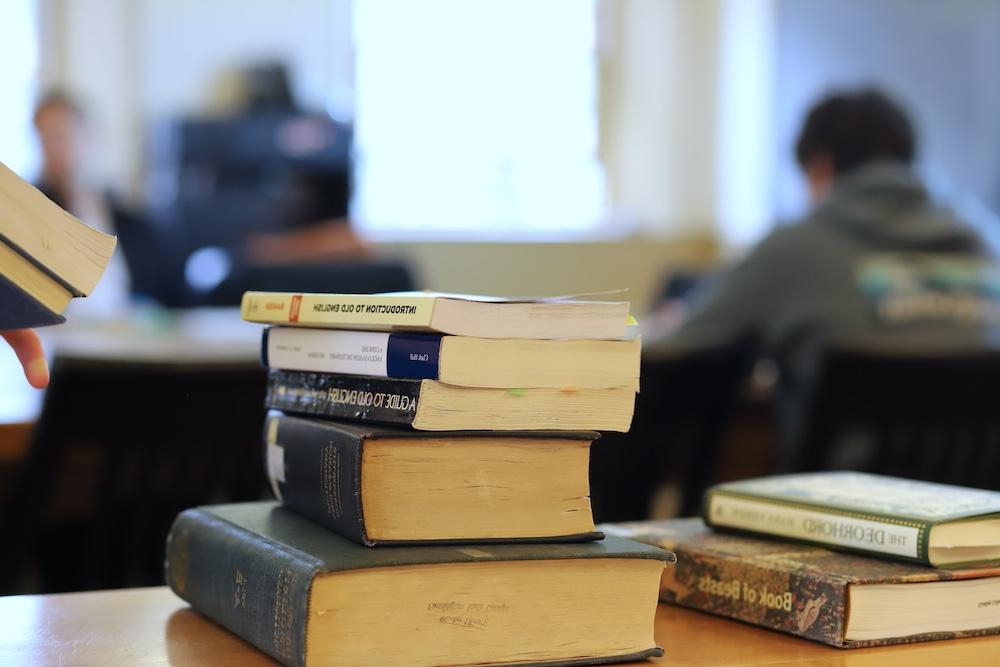 a stack of books in an English classroom